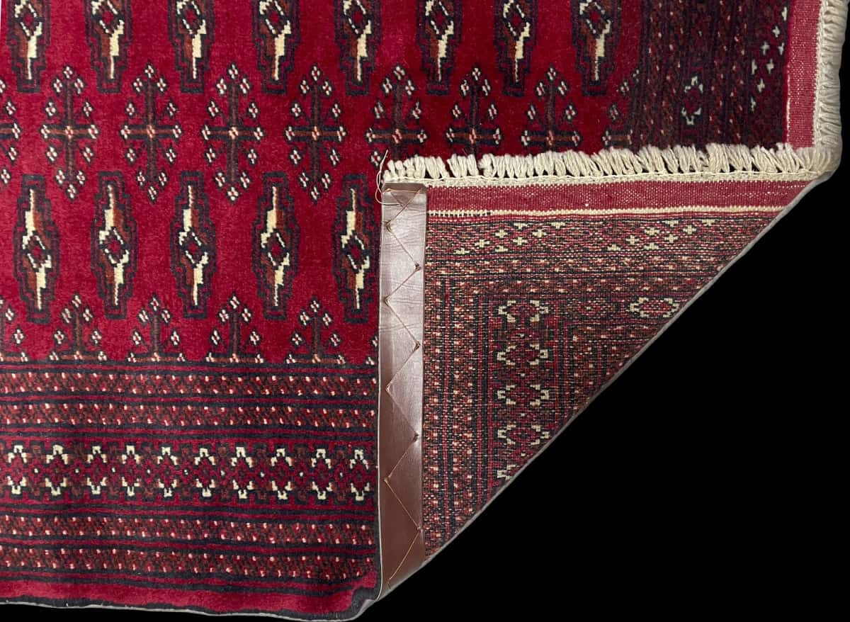 Persian rug of Turkoman style in dimensions 200 centimeters length by 102 centimeters width with mainly red colors — Folded