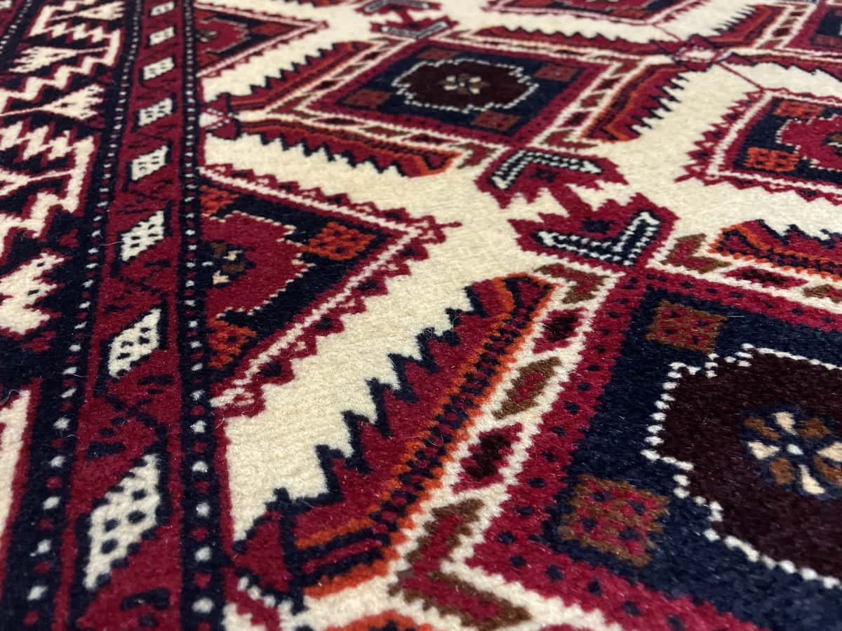 Persian rug of Baluch style in dimensions 196 centimeters length by 96 centimeters width with mainly beige colors — Texture close-up