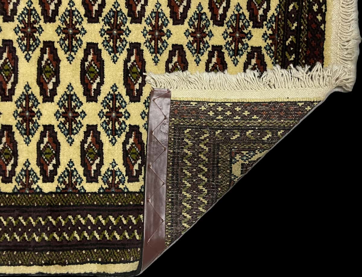 Persian rug in dimensions 116 centimeters length by 78 centimeters width with mainly yellow colors — Folded