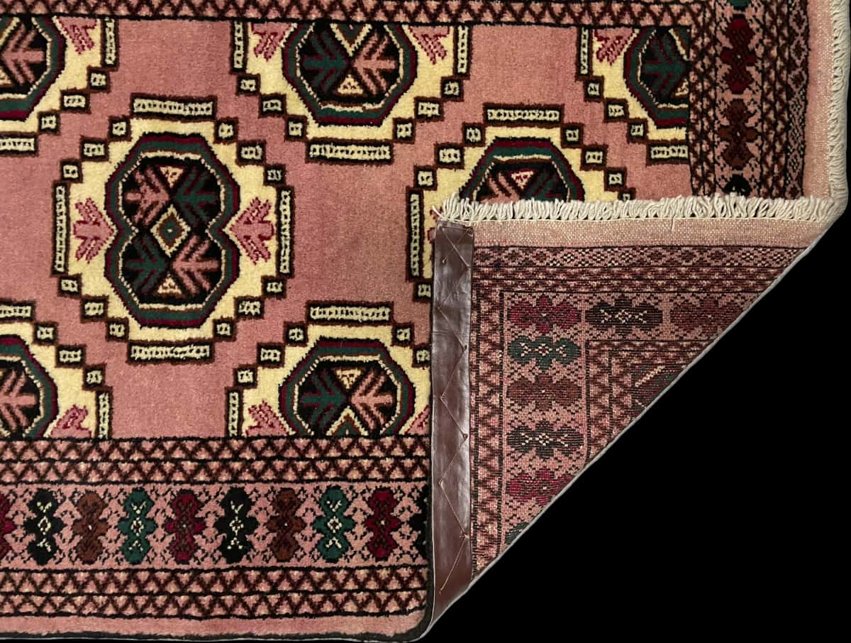 Persian rug of Turkoman style in dimensions 125 centimeters length by 85 centimeters width with mainly pink colors — Folded