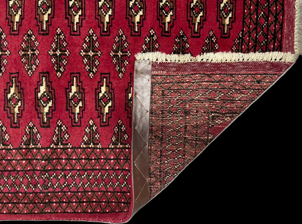 Persian rug of Turkoman style in dimensions 122 centimeters length by 80 centimeters width with mainly red colors — Folded
