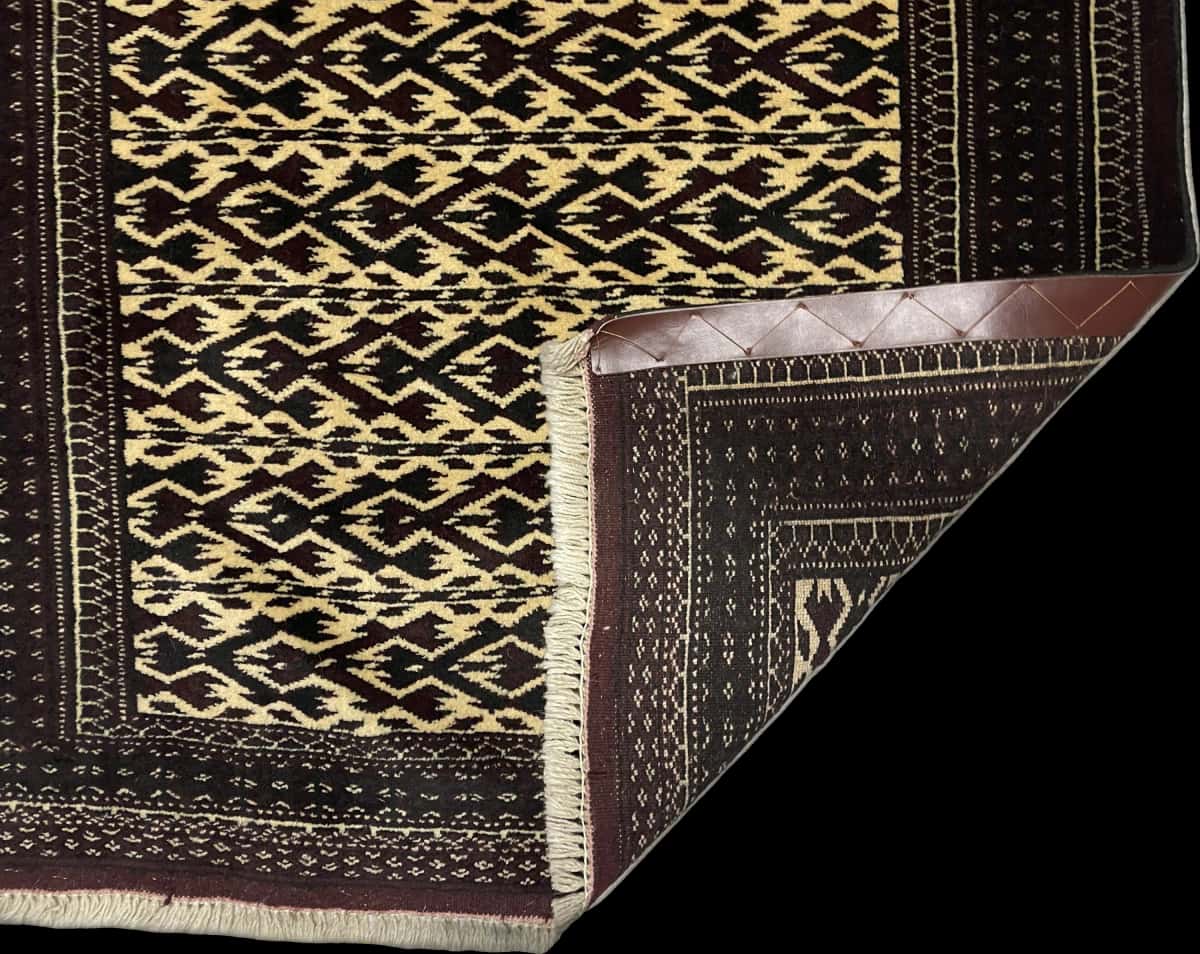 Persian rug of Turkoman style in dimensions 133 centimeters length by 94 centimeters width with mainly brown and beige colors — Folded