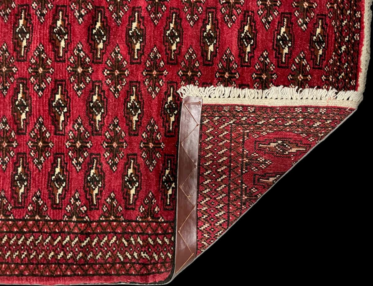 Persian rug of Turkoman style in dimensions 110 centimeters length by 83 centimeters width with mainly red colors — Folded