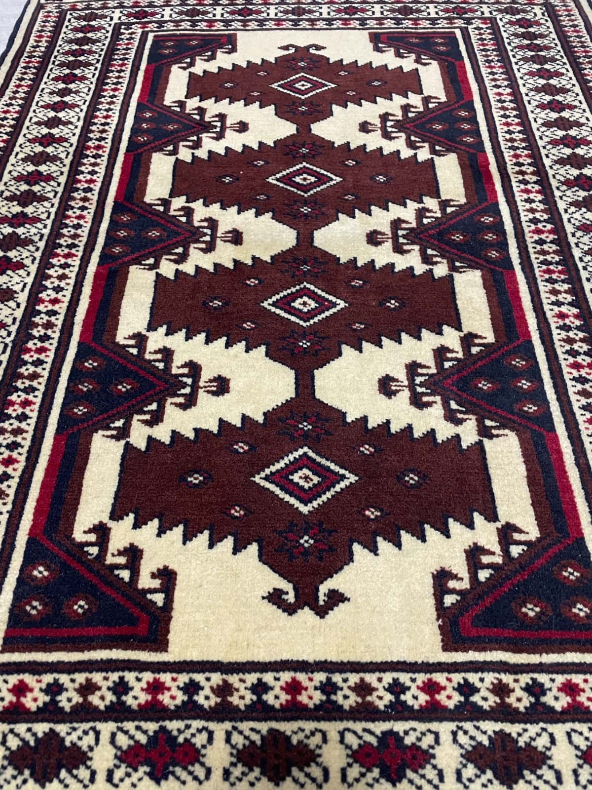 Persian rug in dimensions 112 centimeters length by 79 centimeters width with mainly beige and brown colors — Perspective