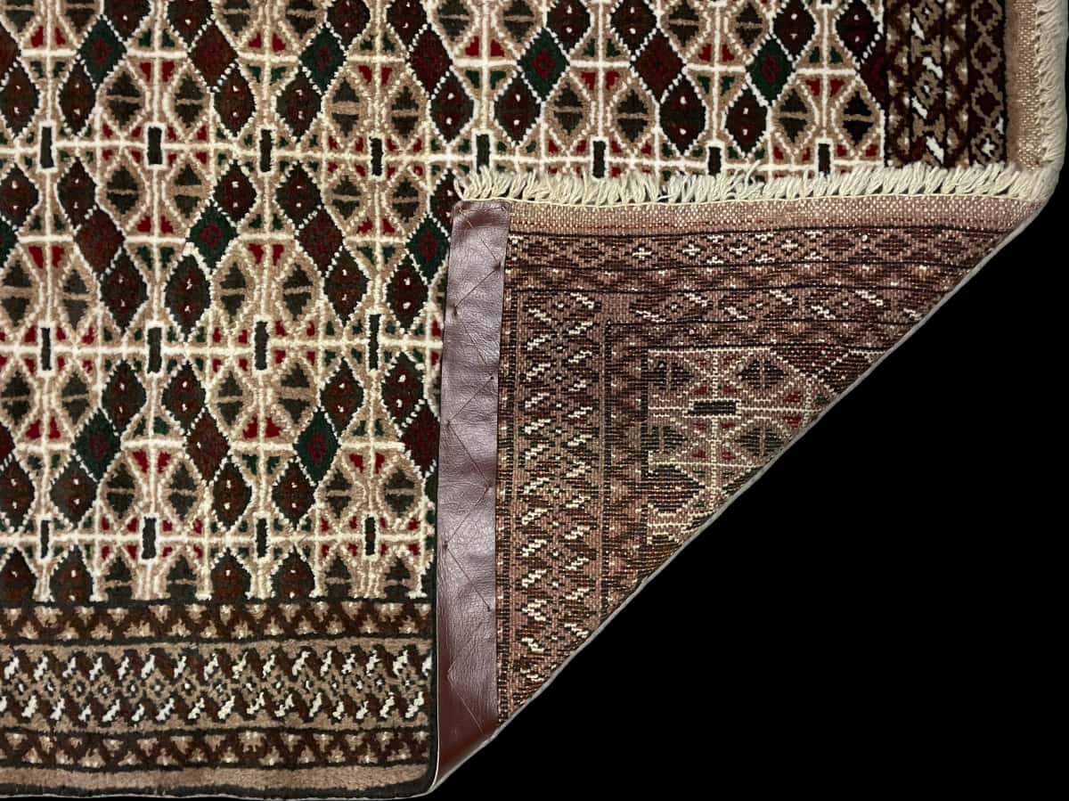 Persian rug of Turkoman style in dimensions 117 centimeters length by 76 centimeters width with mainly brown colors — Folded