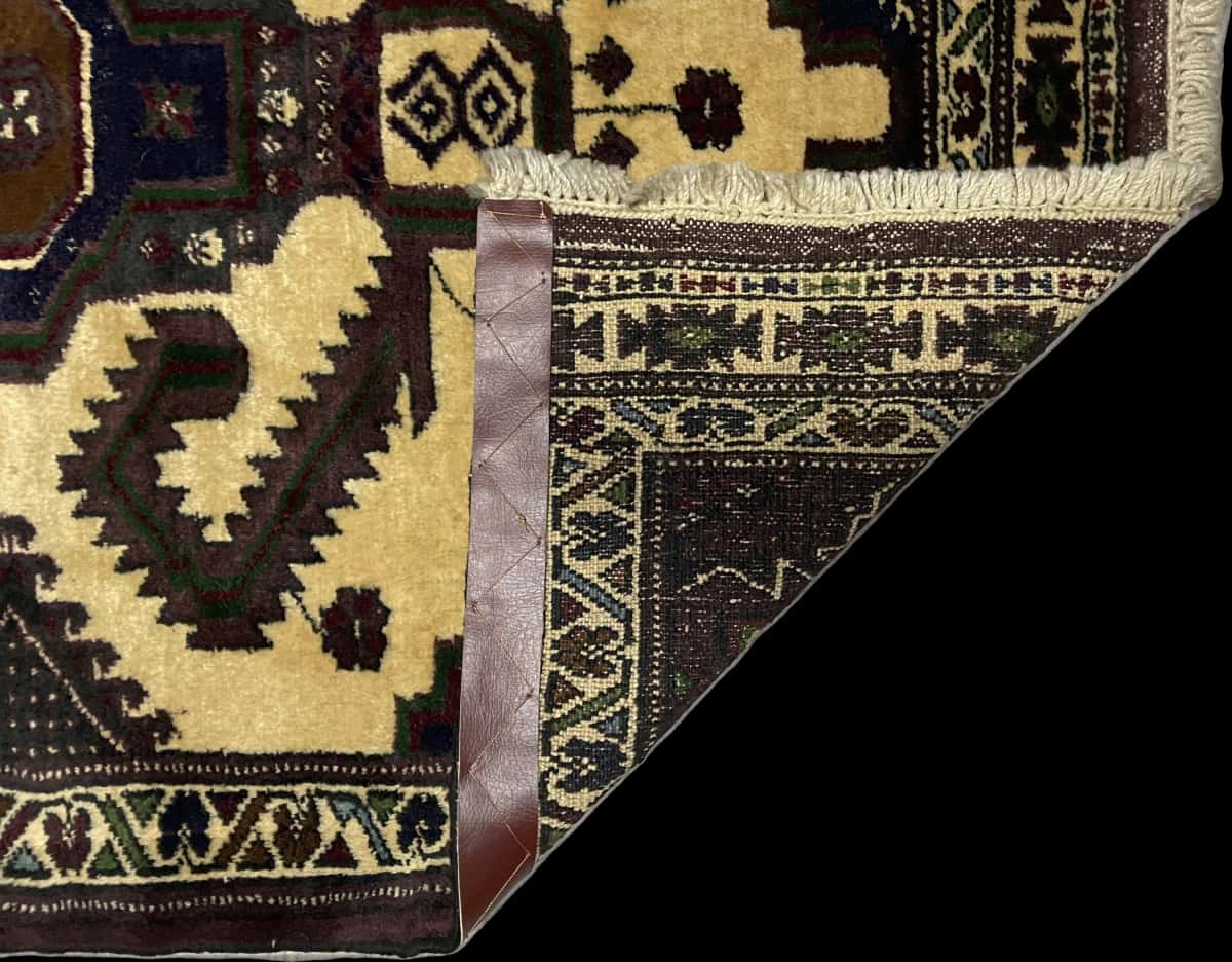 Persian rug of Turkoman style in dimensions 132 centimeters length by 78 centimeters width with mainly brown and yellow colors — Folded