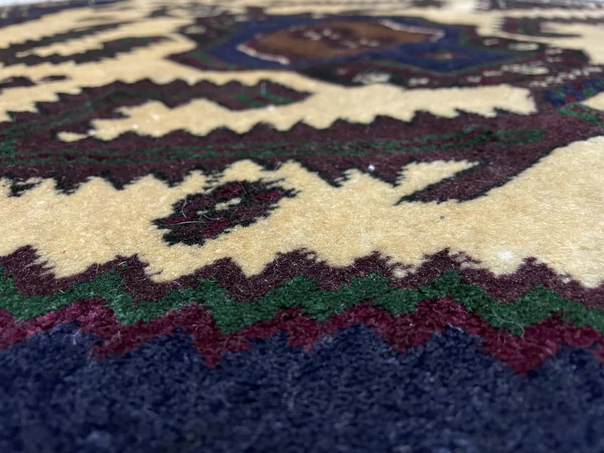 Persian rug of Turkoman style in dimensions 132 centimeters length by 78 centimeters width with mainly brown and yellow colors — Texture close-up