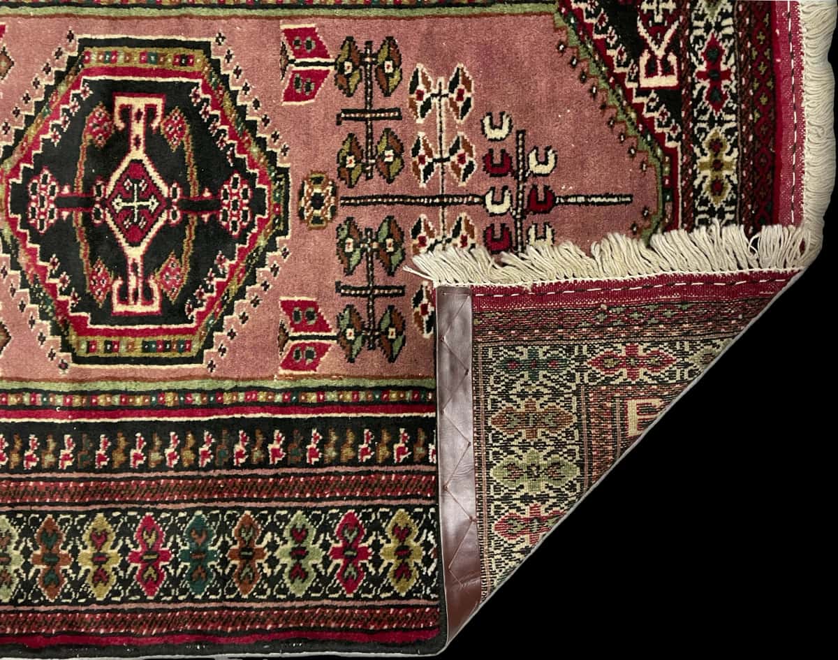 Persian rug of Turkoman style in dimensions 142 centimeters length by 96 centimeters width with mainly pink colors — Folded