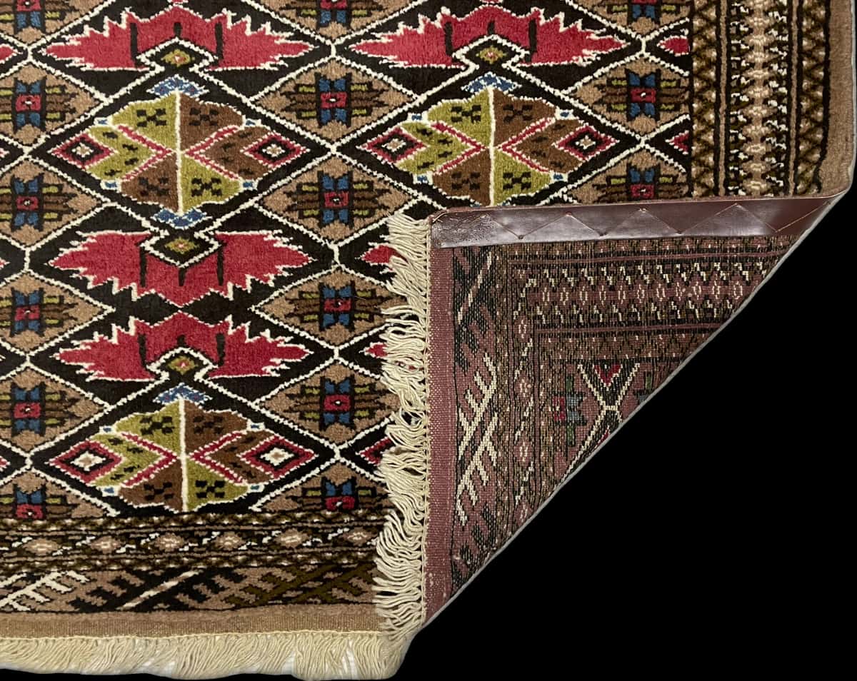 Persian rug of Turkoman style in dimensions 140 centimeters length by 103 centimeters width with mainly brown colors — Folded