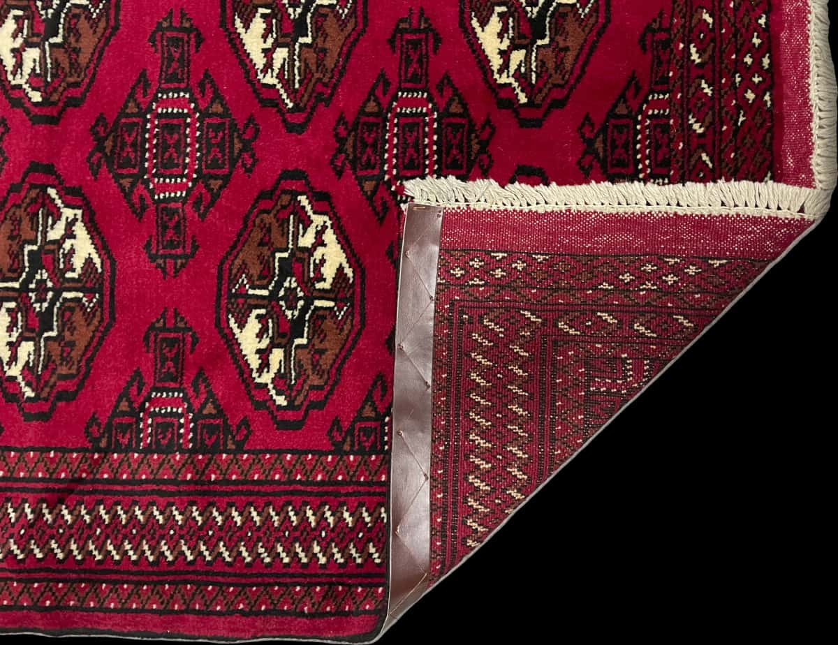 Persian rug of Turkoman style in dimensions 149 centimeters length by 98 centimeters width with mainly red colors — Folded