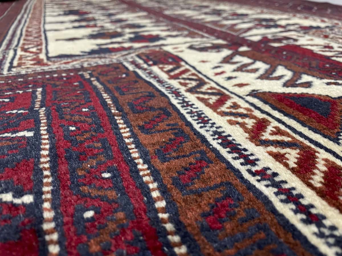 Persian rug of Turkoman style in dimensions 160 centimeters length by 115 centimeters width with mainly red colors — Texture close-up