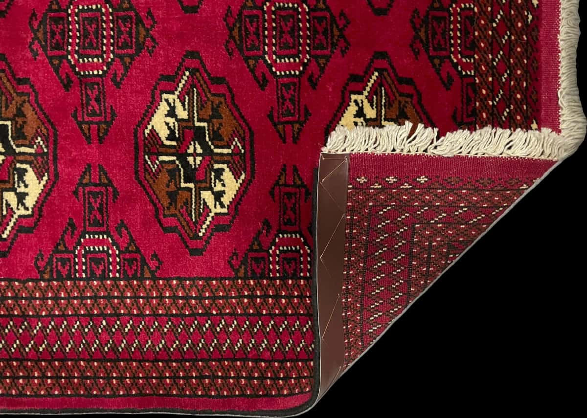Persian rug of Turkoman style in dimensions 147 centimeters length by 98 centimeters width with mainly red colors — Folded