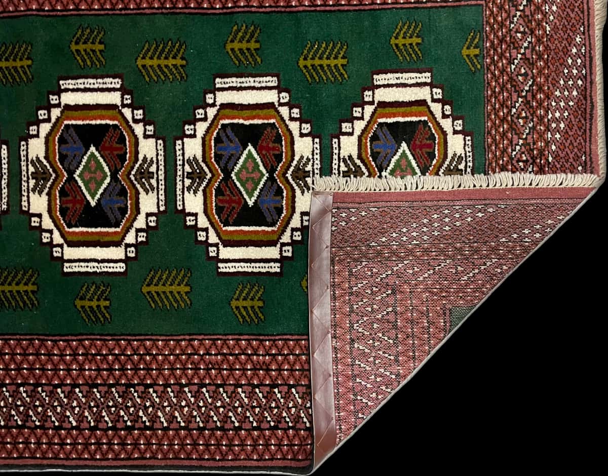 Persian rug of Turkoman style in dimensions 145 centimeters length by 100 centimeters width with mainly green colors — Folded