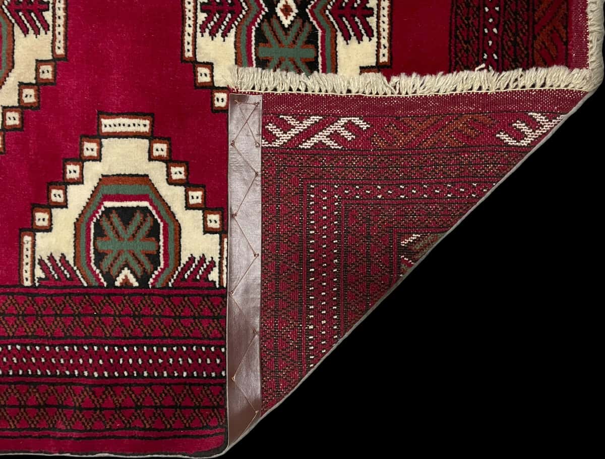 Persian rug of Turkoman style in dimensions 147 centimeters length by 105 centimeters width with mainly red colors — Folded
