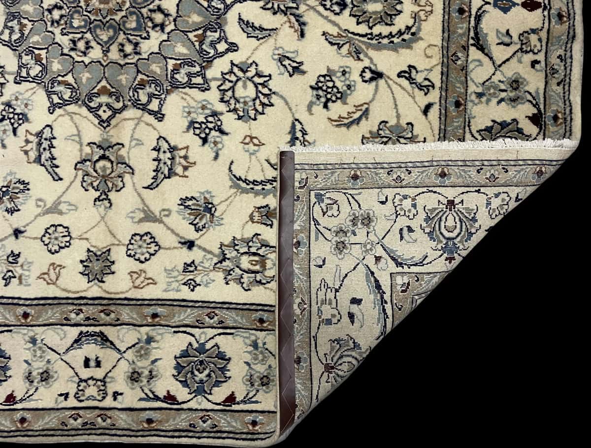 Persian rug of Nain style in dimensions 205 centimeters length by 200 centimeters width with mainly beige colors — Folded
