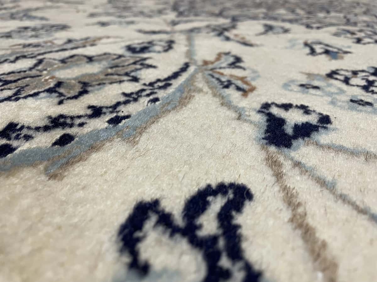 Persian rug of Nain style in dimensions 205 centimeters length by 200 centimeters width with mainly beige colors — Texture close-up