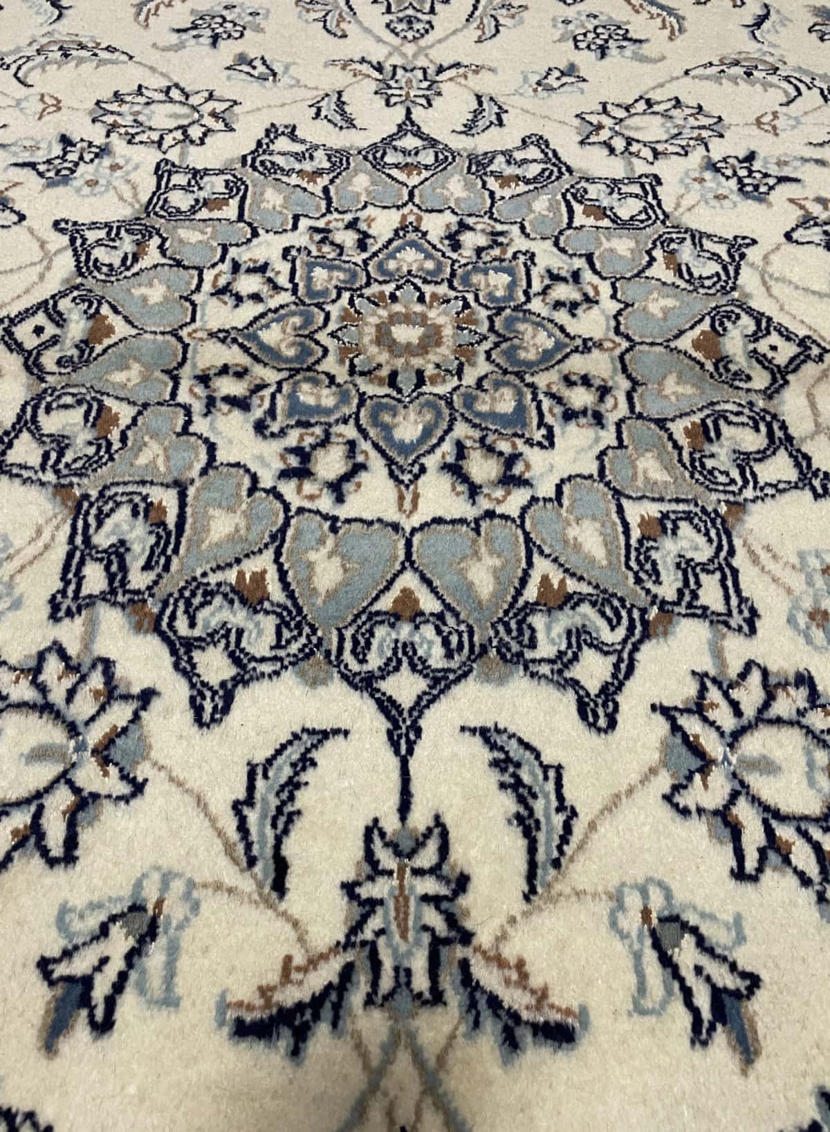 Persian rug of Nain style in dimensions 205 centimeters length by 200 centimeters width with mainly beige colors — Texture close-up