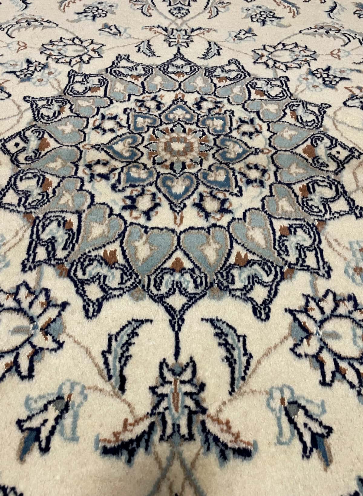 Persian rug of Nain style in dimensions 205 centimeters length by 200 centimeters width with mainly beige colors — Texture close-up