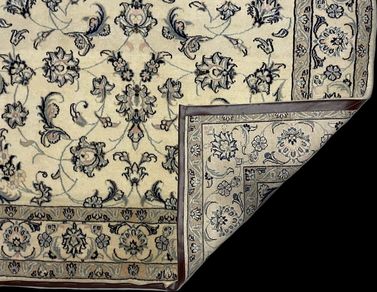 Persian rug of Nain style in dimensions 235 centimeters length by 160 centimeters width with mainly beige and blue colors — Folded