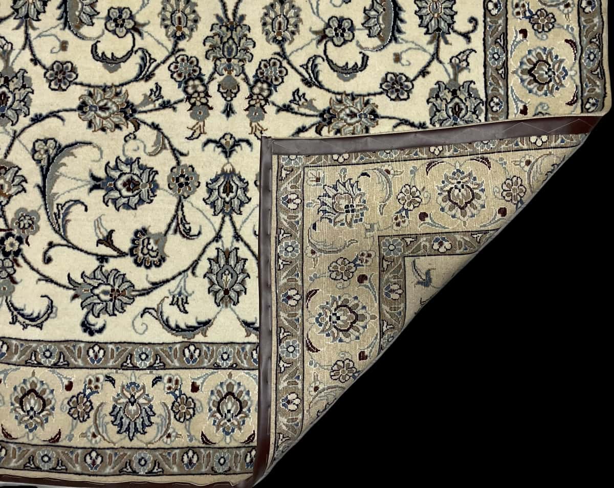 Persian rug of Nain style in dimensions 240 centimeters length by 162 centimeters width with mainly beige and blue colors — Folded