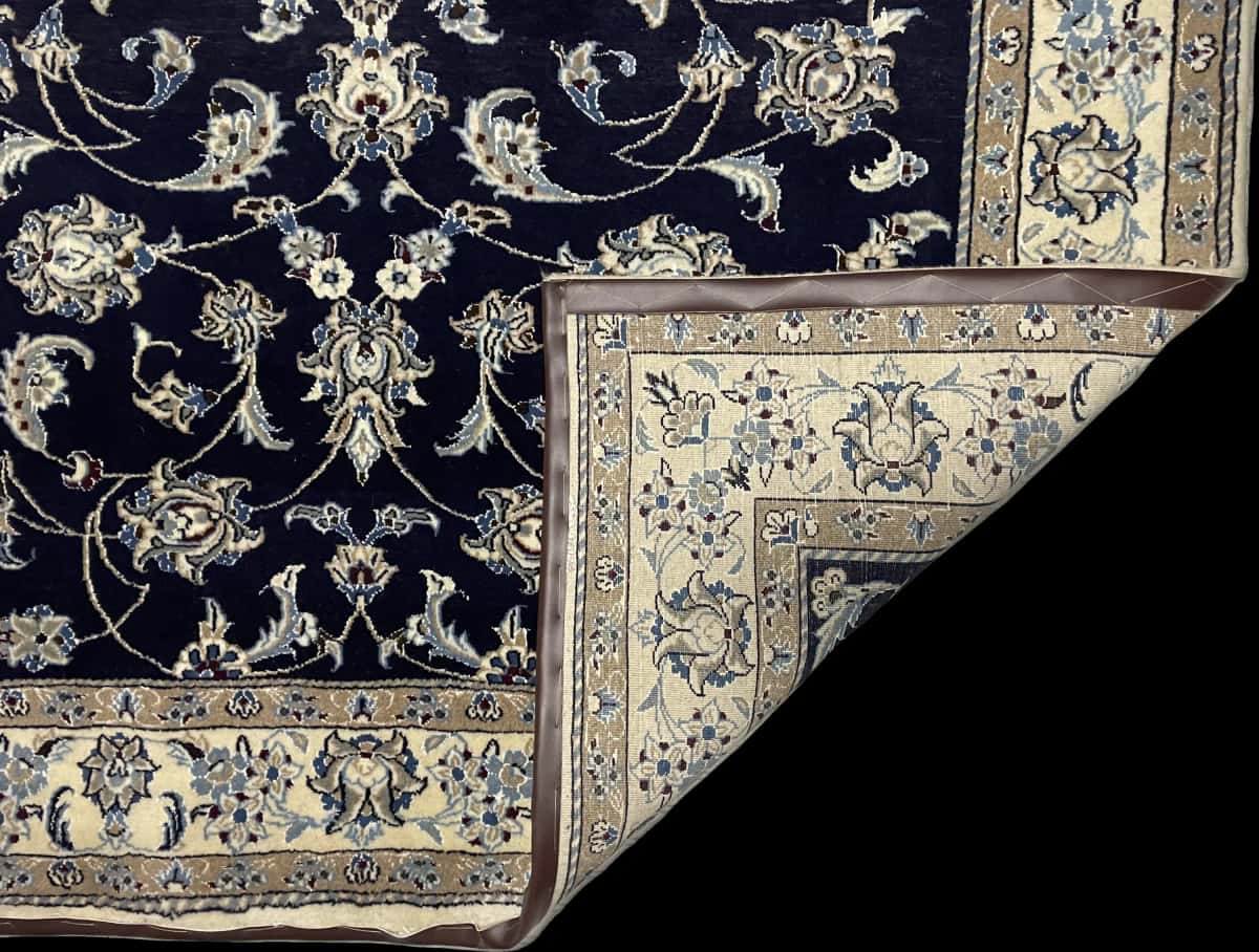 Persian rug of Nain style in dimensions 234 centimeters length by 168 centimeters width with mainly blue colors — Folded