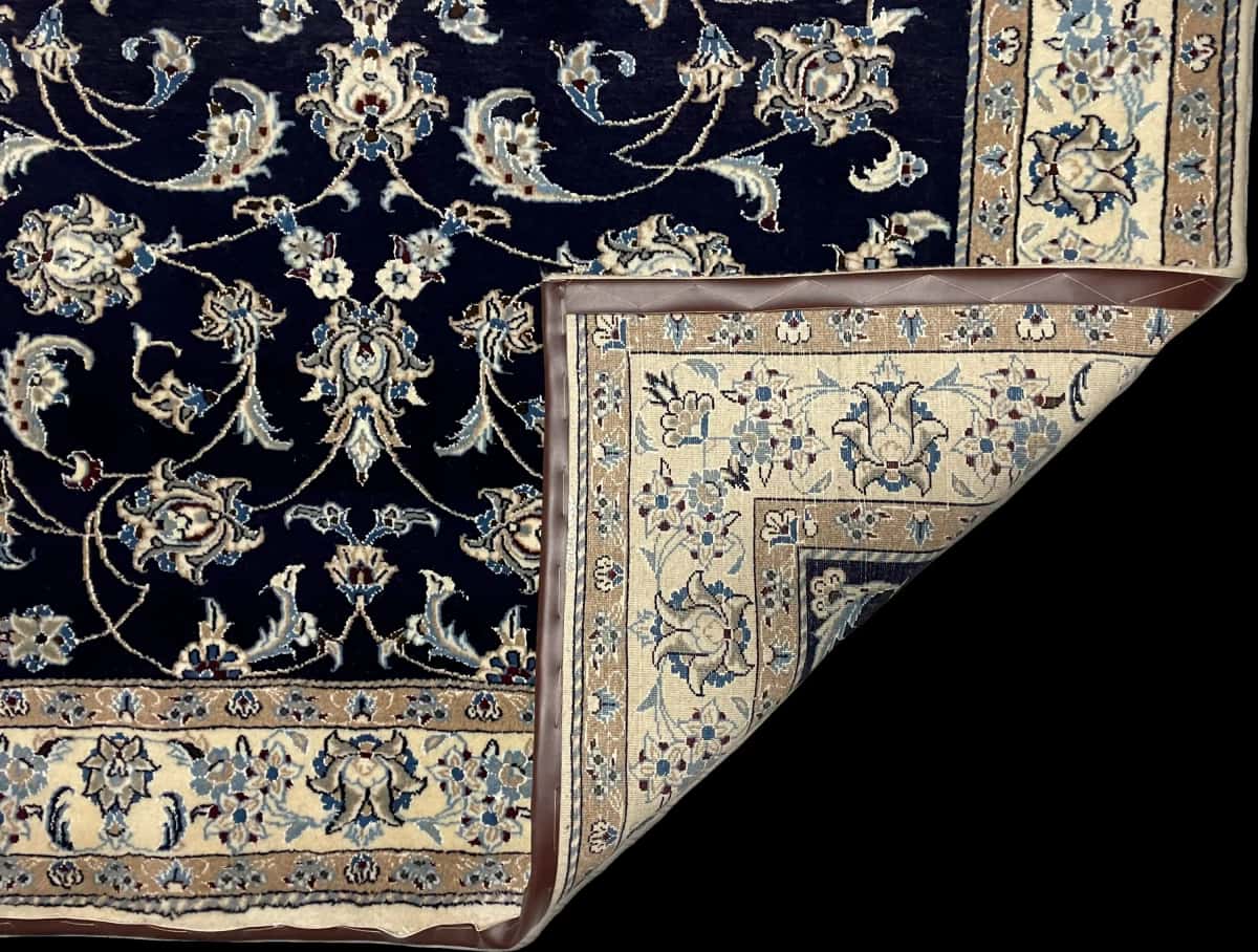 Persian rug of Nain style in dimensions 234 centimeters length by 168 centimeters width with mainly blue colors — Folded