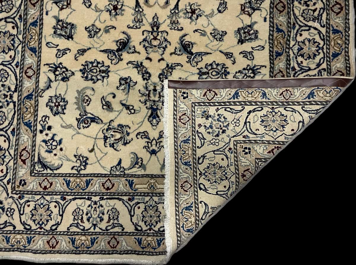 Persian rug of Nain style in dimensions 230 centimeters length by 159 centimeters width with mainly beige and blue colors — Folded