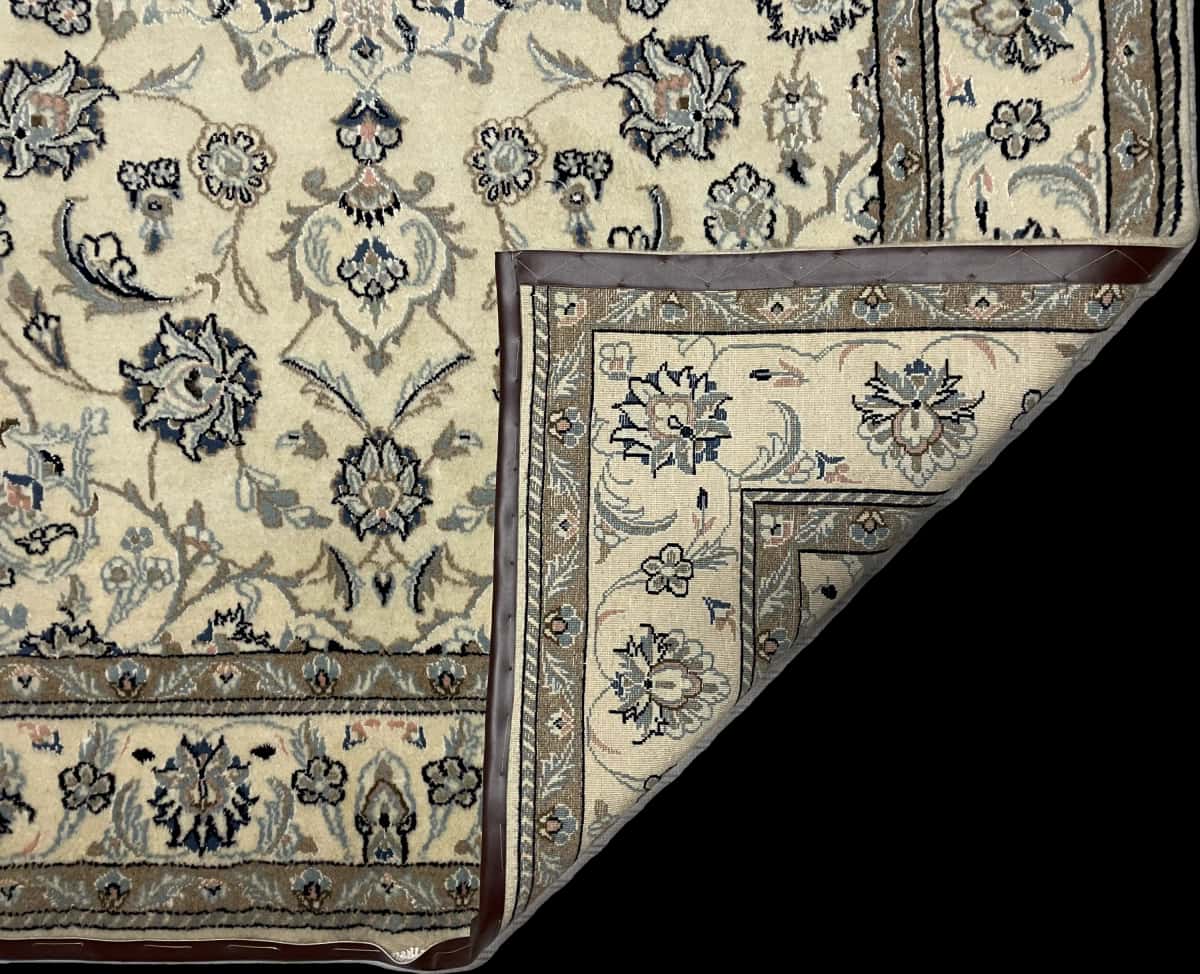 Persian rug of Nain style in dimensions 230 centimeters length by 162 centimeters width with mainly beige colors — Folded