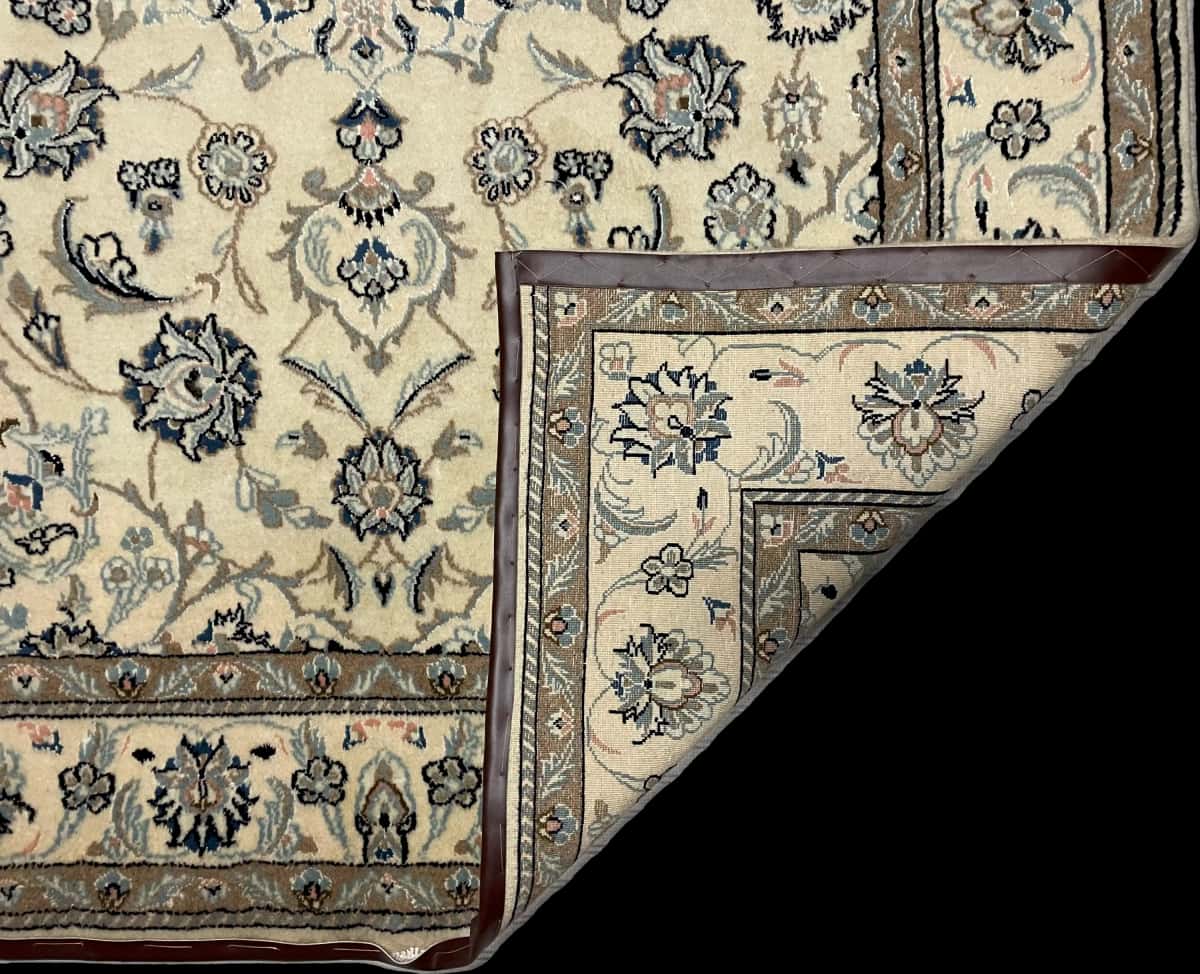Persian rug of Nain style in dimensions 230 centimeters length by 162 centimeters width with mainly beige colors — Folded