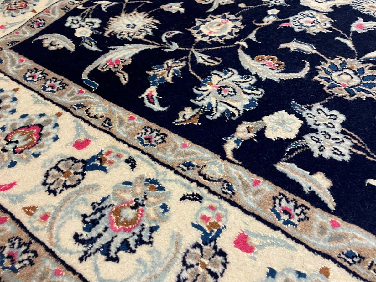 Persian rug of Nain style in dimensions 232 centimeters length by 168 centimeters width with mainly blue colors — Texture close-up