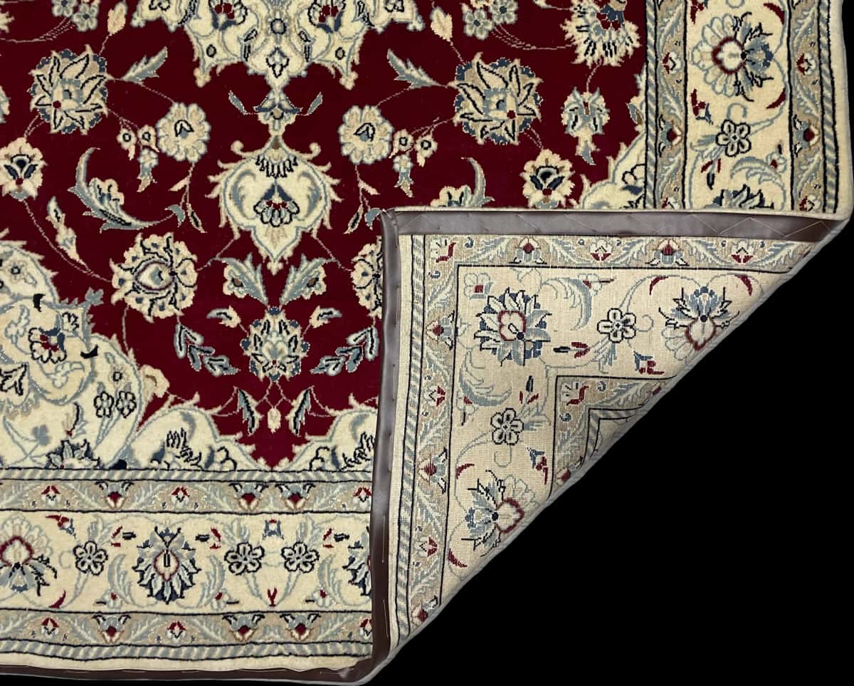 Persian rug of Nain style in dimensions 240 centimeters length by 170 centimeters width with mainly beige and red colors — Folded