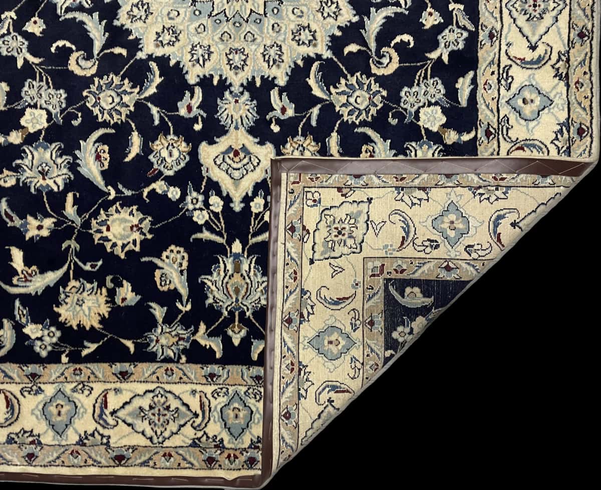 Persian rug of Nain style in dimensions 234 centimeters length by 165 centimeters width with mainly blue colors — Folded