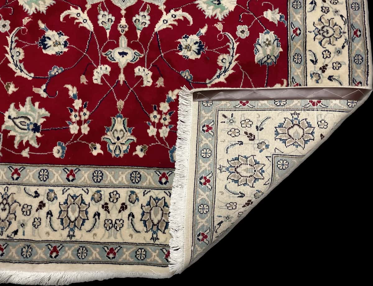 Persian rug of Nain style in dimensions 208 centimeters length by 150 centimeters width with mainly red colors — Folded
