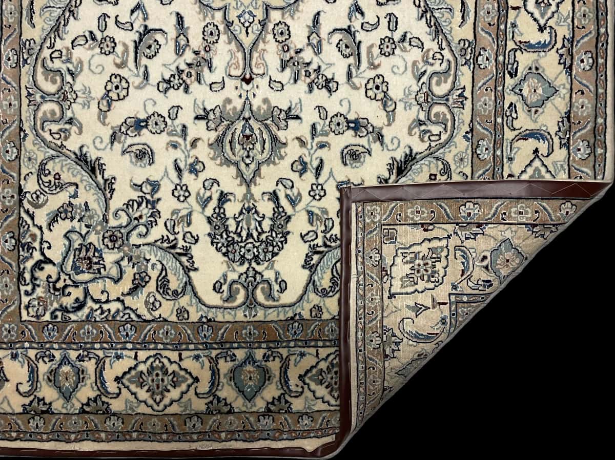 Persian rug of Nain style in dimensions 255 centimeters length by 164 centimeters width with mainly white and blue colors — Folded