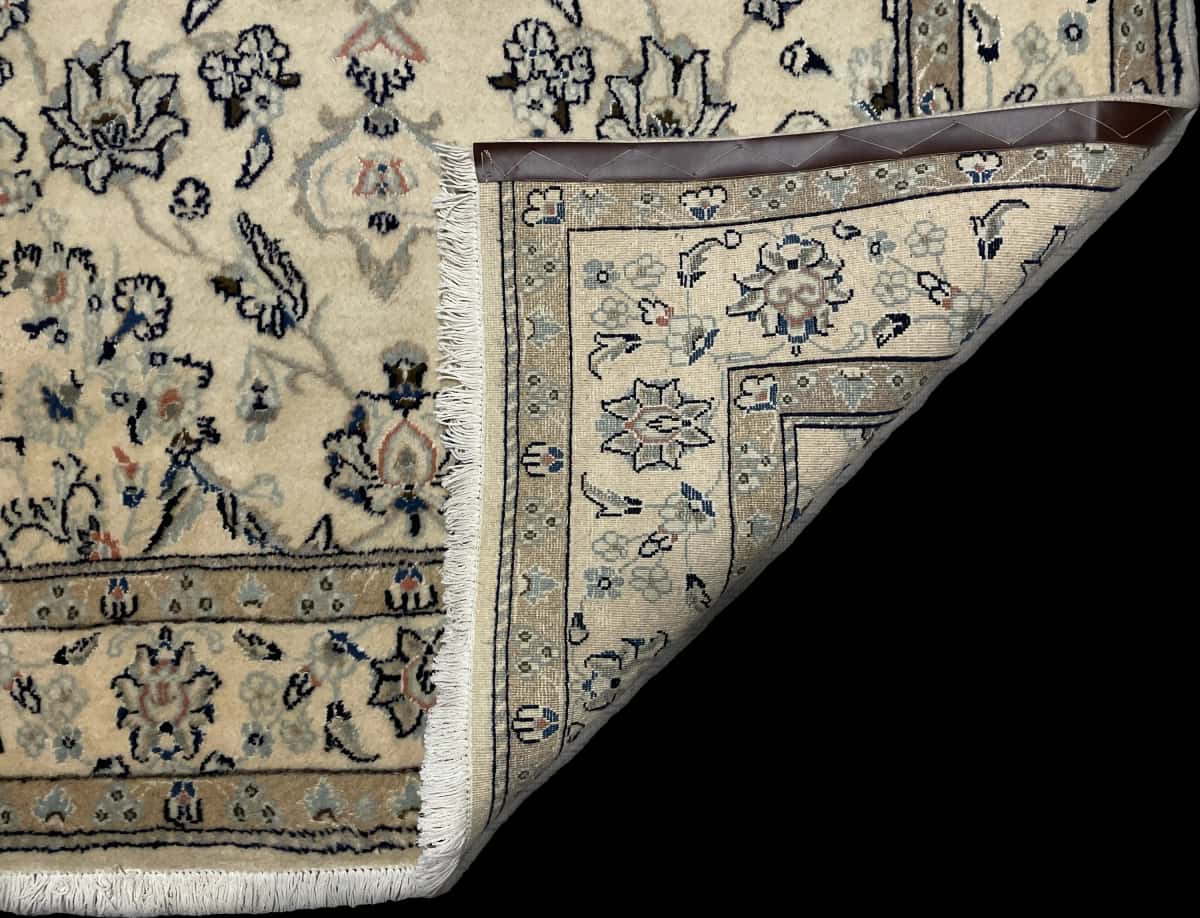 Persian rug of Nain style in dimensions 206 centimeters length by 145 centimeters width with mainly beige colors — Folded