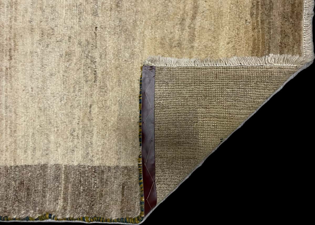 Persian rug of Gabbeh style in dimensions 140 centimeters length by 102 centimeters width with mainly beige colors — Folded