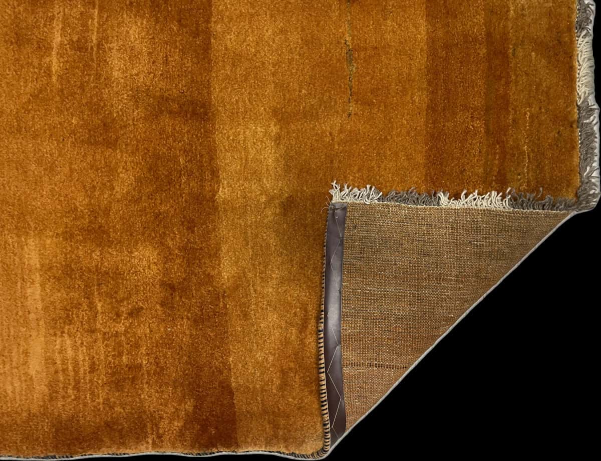 Persian rug of Gabbeh style in dimensions 150 centimeters length by 106 centimeters width with mainly orange colors — Folded