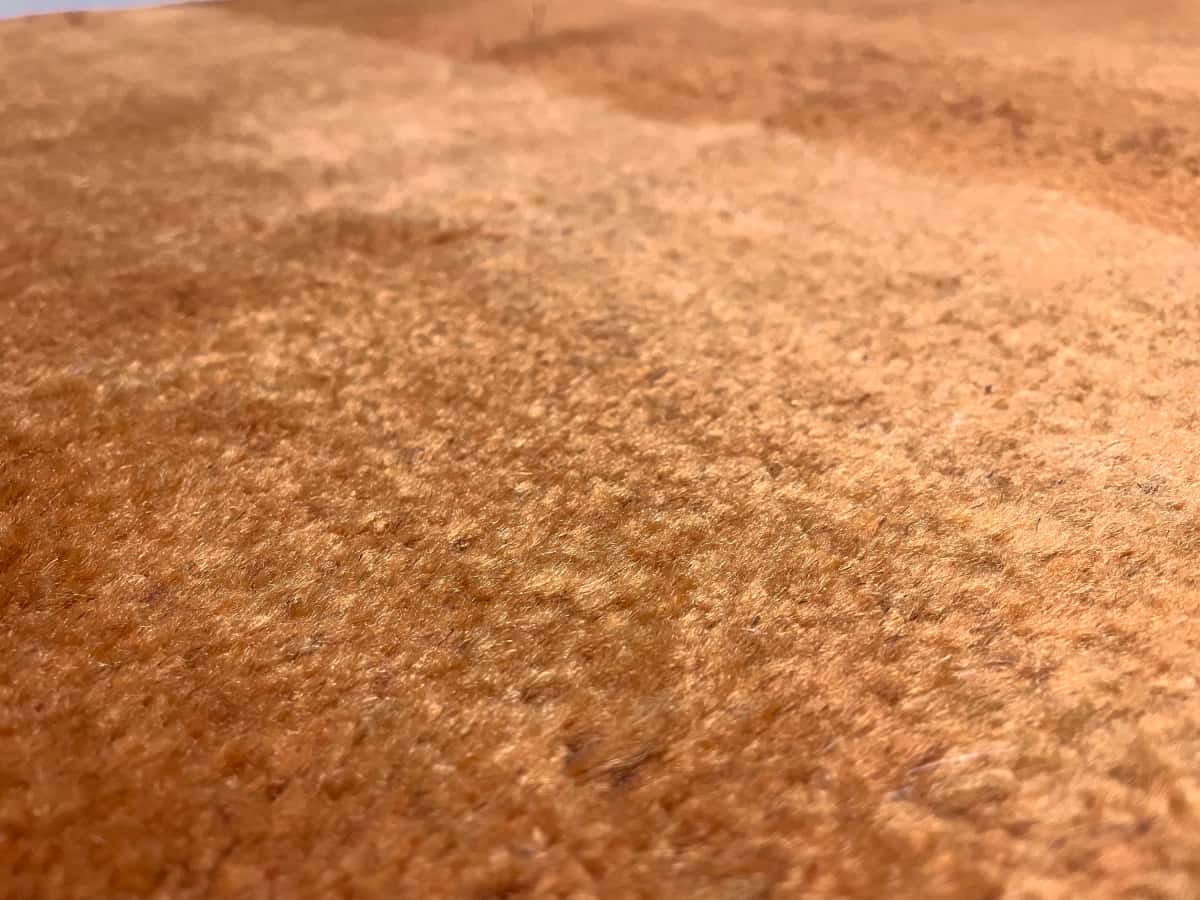 Persian rug of Gabbeh style in dimensions 150 centimeters length by 106 centimeters width with mainly orange colors — Texture close-up