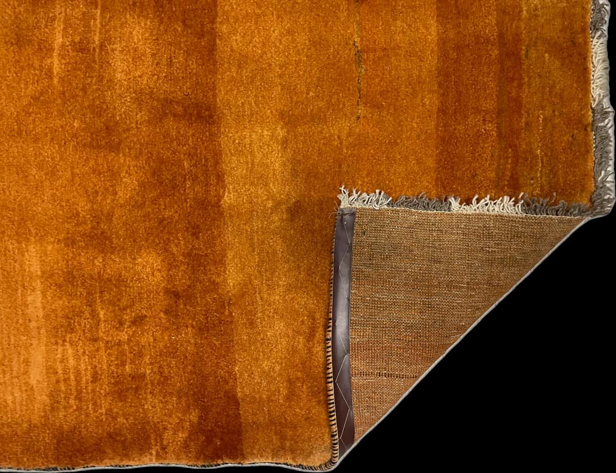 Persian rug of Gabbeh style in dimensions 150 centimeters length by 106 centimeters width with mainly orange colors — Folded