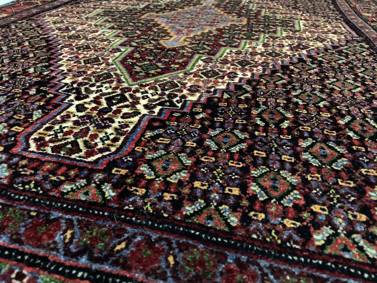 Persian rug of Sanandaj style in dimensions 182 centimeters length by 130 centimeters width with mainly colorful colors — Texture close-up