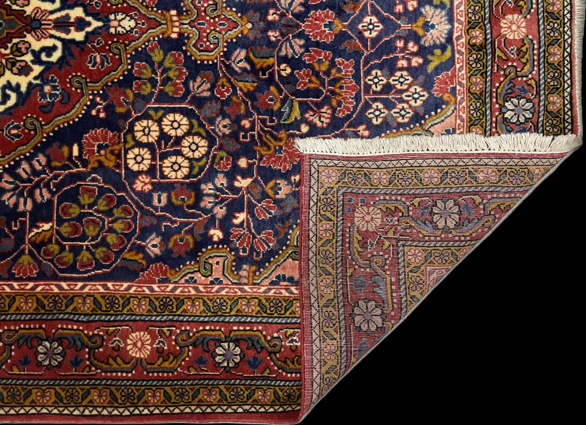 Persian rug of Malayer style in dimensions 209 centimeters length by 131 centimeters width with mainly red and blue colors — Folded