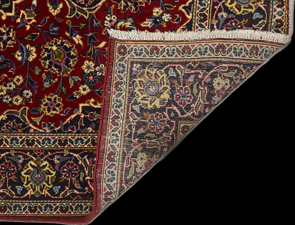 Persian rug of Kashan style in dimensions 164 centimeters length by 105 centimeters width with mainly red and blue colors — Folded