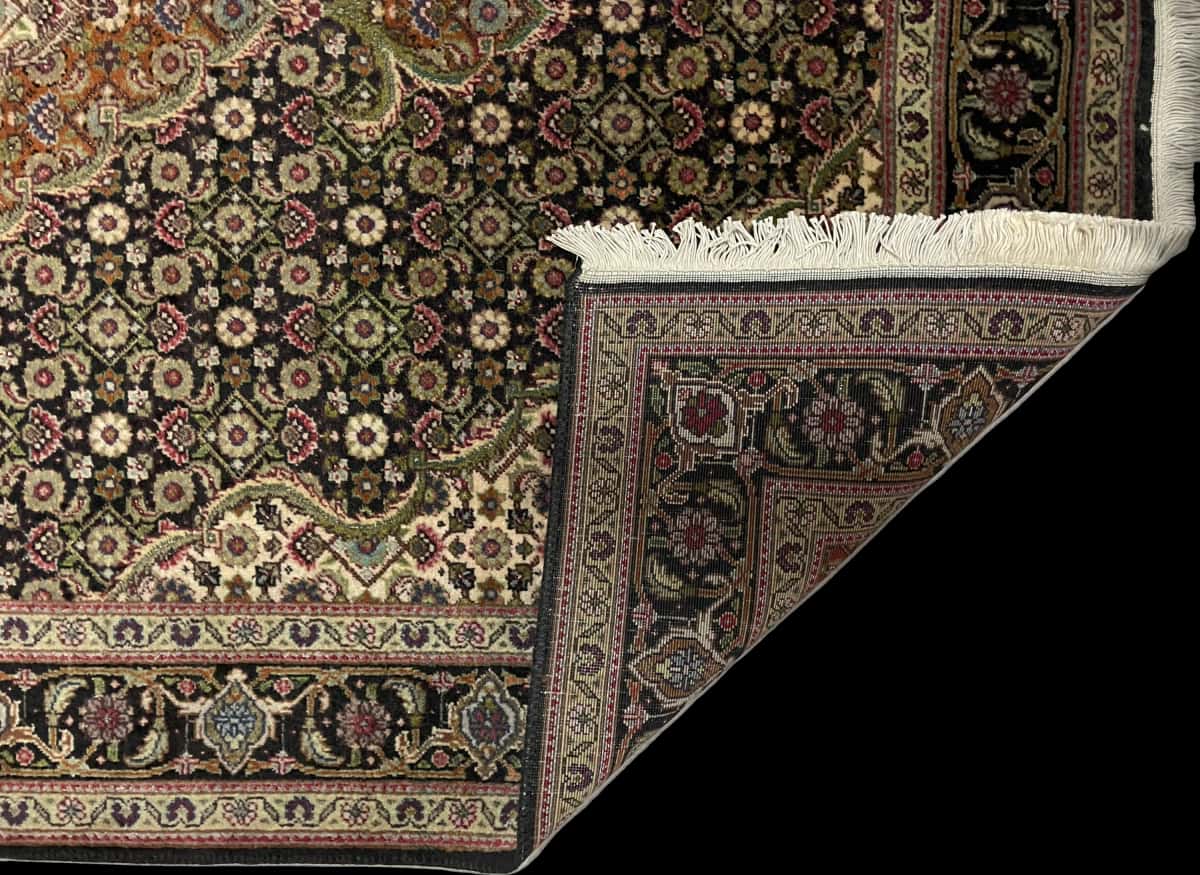 Persian rug of Khoy style in dimensions 150 centimeters length by 100 centimeters width with mainly brown and black colors — Folded