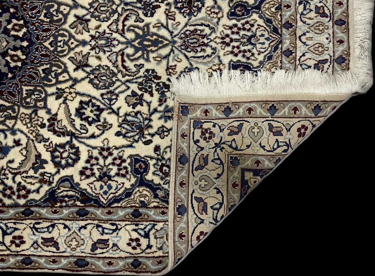 Persian rug in dimensions 202 centimeters length by 122 centimeters width with mainly blue and beige colors — Folded