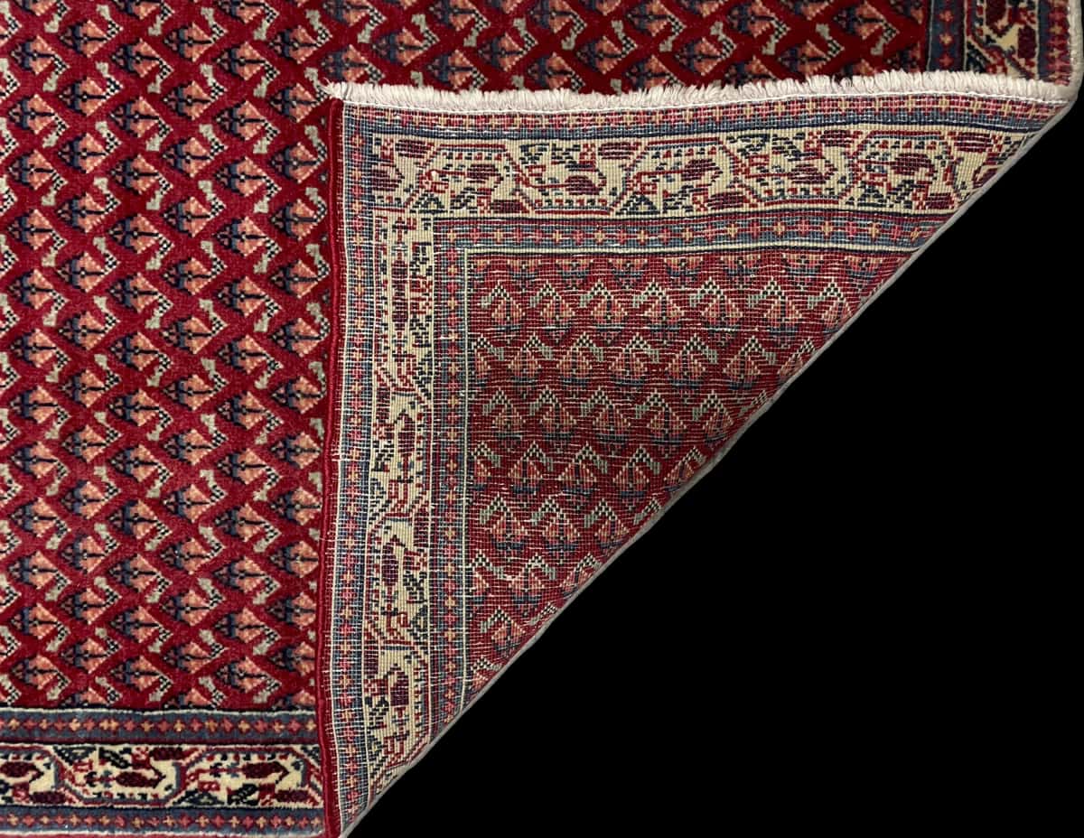 Persian rug of Arak style in dimensions 115 centimeters length by 67 centimeters width with mainly red and blue colors — Folded