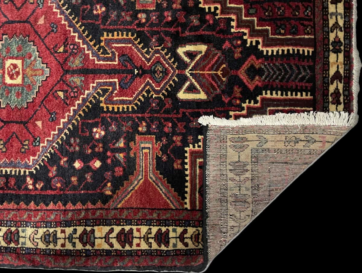 Persian rug of Hamadan style in dimensions 170 centimeters length by 103 centimeters width with mainly red and blue colors — Folded
