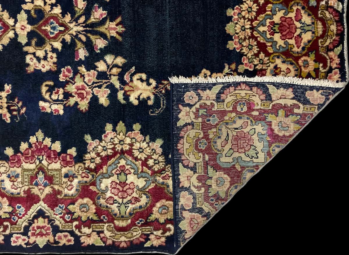 Persian rug of Kerman style in dimensions 217 centimeters length by 123 centimeters width with mainly red and blue colors — Folded