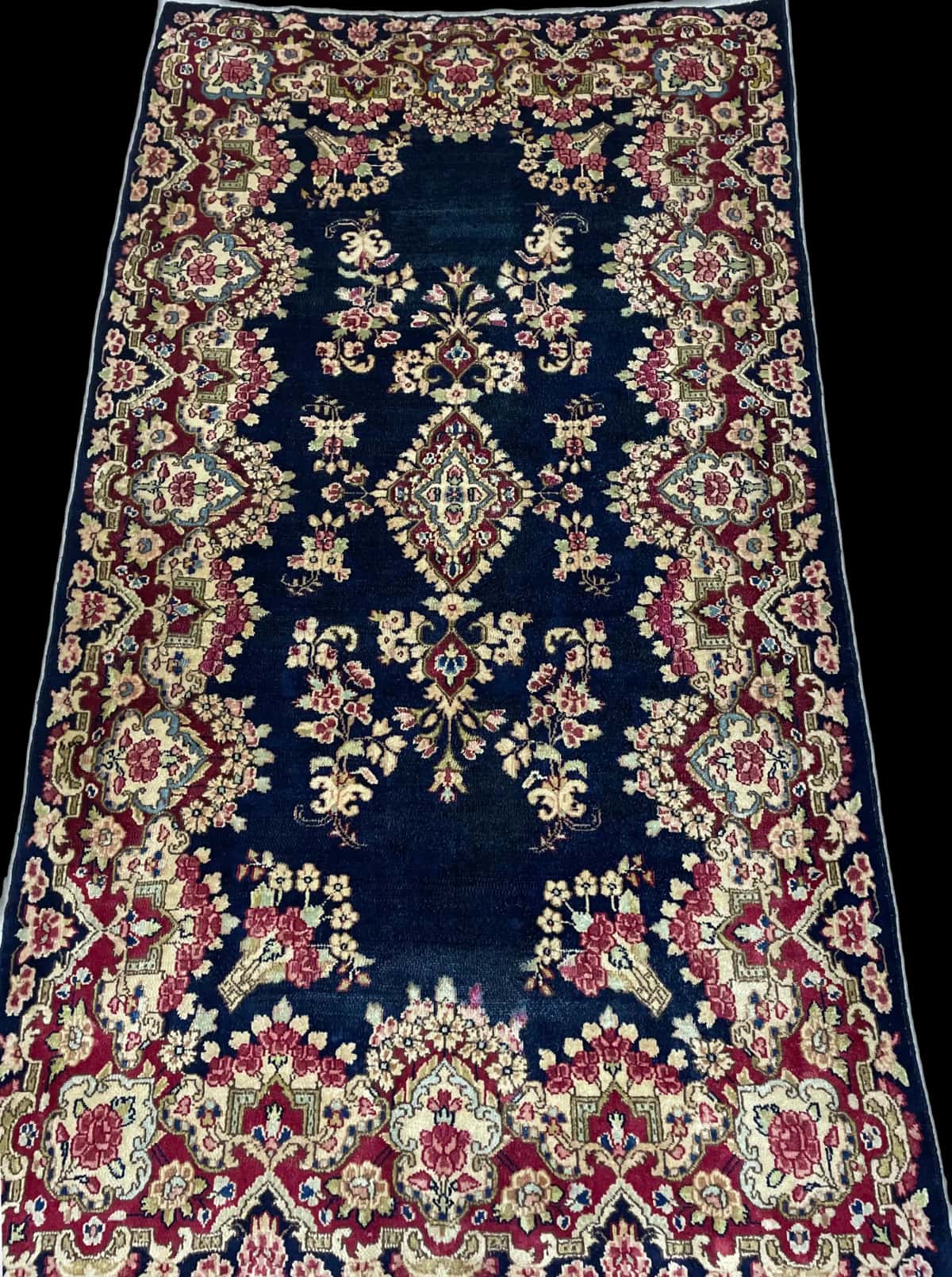 Persian rug of Kerman style in dimensions 217 centimeters length by 123 centimeters width with mainly red and blue colors — Perspective
