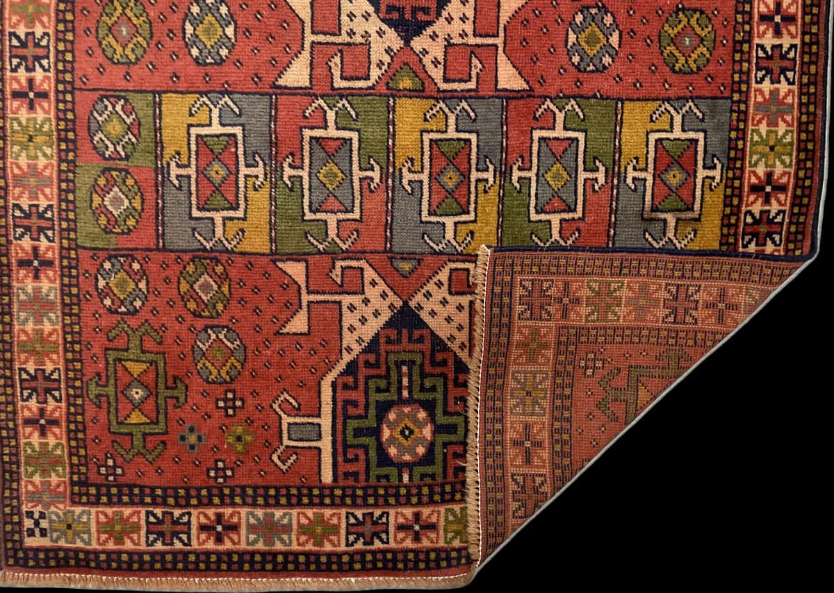 Persian rug of Quchan style in dimensions 202 centimeters length by 108 centimeters width with mainly red and blue colors — Folded