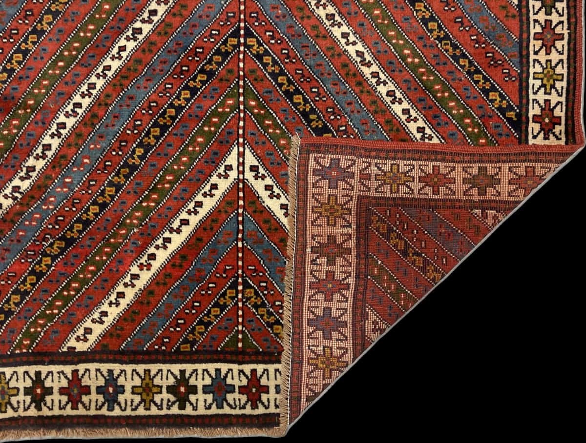Persian rug of Quchan style in dimensions 200 centimeters length by 123 centimeters width with mainly red and green colors — Folded
